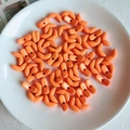 Close-up of orange acrylic wheat ear beads for DIY jewelry making in a white ceramic dish - Orange Moon Shaped Bead (1#)