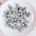 Macro detail of glossy grey sunflower seed beads for DIY jewelry and phone chain accessories - Gray Flower Bud Bead (05#)