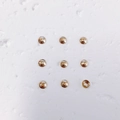 Macro detail of nine 18K gold-plated round bead spacers for jewelry making - Style 1 (1#) / Small / 14K Gold