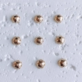 Macro detail of nine 18K gold plated hollow floral spacer beads for jewelry making - Style 5 (5#)