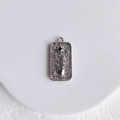 Detailed view of rectangular silver pendant with embossed palm and black crystal star - Sun God Pendant (White K)