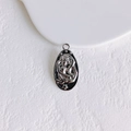 Macro detail of oval sun gold coin pendant with embossed figures and star patterns - Silver Oval Relief (2#)