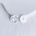 Macro detail of white irregular dual-hole buttons with elegant matte texture and relief - White Button (15# Medium)