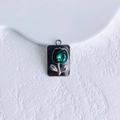 Close-up of a silver tulip heart pendant with a faceted green teardrop gemstone - Silver Green Tulip Rectangle (10#)