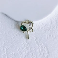 Macro shot of gold heart pendant with pear-shaped green gem and white zircon accents - Gold Green Open Heart (12#)