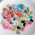 Macro shot of colorful letter E beads for DIY jewelry making in various pastel shades - Mixed Colors