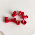 Detail view of seven red macaron style mini boot charms for DIY jewelry making - Red (6)