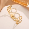 Luxurious gold hollow circle bangle with crystal pave details in premium titanium steel - Gold
