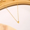 Detailed macro view of a heart-shaped yellow gemstone pendant on a gold stainless steel chain - November (Yellow)