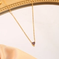 Macro detail of gold stainless steel heart pendant necklace with purple gemstone - June (Purple)