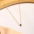 Macro view of a heart-shaped black gemstone pendant on a gold chain with claw setting - September (Black)