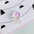 DIY translucent resin lollipop charm with pink spiral patterns and yellow bow decoration - Style 1