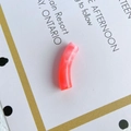 Macro detail of curved acrylic bead with pink orange marble texture for DIY jewelry - Pink Orange Cloud Pattern