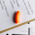 Close-up of a bright orange resin curved tube bead for DIY necklace and bracelet making - 10 Pieces Pack / Orange
