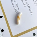 Macro view of a curved translucent acrylic bead with amber marble patterns for DIY jewelry - White Amber Texture