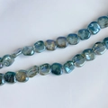 Macro view of iridescent blue-green laser glass beads in irregular square shape - Aurora Blue-Green (7#) / Approx 60 Beads/Strand