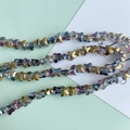 Macro detail of iridescent glass butterfly beads with gradient electroplated finish - Iridescent Black (9#)