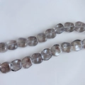 Close-up of translucent smoky gray square glass beads with a shimmering laser finish - Aurora Smoky Gray (15#) / Approx 60 Beads/Strand