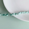 Macro detail of light green flat ceramic disc beads for DIY jewelry making and crafts - Light Cyan Flat Round Style (4#)