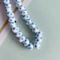 Macro-opname van ovale witte keramische kralen met blauwe stippen voor DIY-sieraden - Blauwe Stippen (1#)