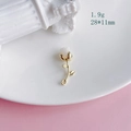Detail view of a 28x11mm golden rose pendant with a white flower bud on a ceramic plate - 1# Gold White Rose (KP5023)
