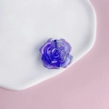 Macro detail of a purple acrylic rose bead with aurora coating on a white ceramic tray - 6# Aurora Iridescent Purple