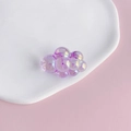 Macro detail of purple iridescent chubby cloud charm with aurora finish on ceramic tray - 3#