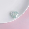 Close-up of light blue faceted acrylic heart pendant with hollow center on white plate - Light Blue (3#)