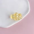 Macro shot of a yellow translucent chubby cloud acrylic charm with laser iridescent gloss - 5#