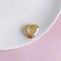 Detailed view of iridescent amber resin hollow heart charm with faceted cutting - Amber Honey (7#)