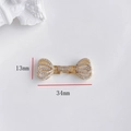 Detail of gold-plated flower bow connector with cubic zirconia, size 34mm by 13mm - Crown Buckle