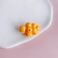Close-up of orange acrylic puffy cloud bead with center hole for DIY jewelry making - 22#