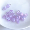 Macro view of iridescent light purple tulip flower beads for DIY jewelry making - Lavender