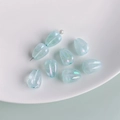 Detailed macro view of translucent light blue tulip petal beads with iridescent finish - Light Blue