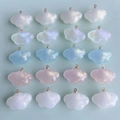 Détail macro de pendentifs nuages en résine nacrée irisés avec boucles dorées pour bijoux DIY - Couleurs mélangées au hasard