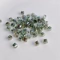 Macro view of faceted cube glass beads with iridescent olive green finish and center hole - Olive Green AB