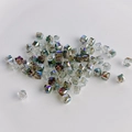 Detailed view of faceted geometric square crystal glass beads with AB iridescent finish - Translucent Colorful AB
