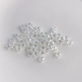 Macro shot of faceted clear AB crystal glass cube beads with rainbow light refraction - Aurora AB White