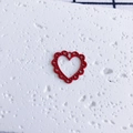 Close-up of bright red heart pendant with hollow heart patterns for DIY jewelry making - Hollow Red Heart