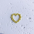 Detail of yellow heart-shaped pendant with hollow lace design for DIY jewelry making - Hollow Yellow Heart