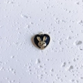 Detail of heart pendant with golden rabbit relief on black enamel background - Heart Rabbit Black and Gold