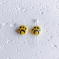 Detailed view of yellow ceramic beads with hand-painted paw prints and central hole - Cat Paw Pattern / 12x8mm / Yellow (1#)