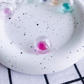 Close-up of colorful iridescent glass bubble charms with liquid filling for DIY jewelry - 3#Rose Pink