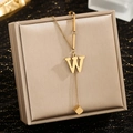 Detail of gold letter W pendant with square charm on a fine stainless steel chain - Letter W
