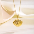 Close-up of golden shell pendant with pearl accent on a fine stainless steel chain - Pearl Shell Necklace (Gold)