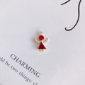 Macro shot of an angel charm featuring faceted red crystal and golden wings on a card - Ruby Red (3#)