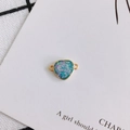 Macro shot of heart-shaped resin pendant with gold copper trim and dual side hanging loops - Iridescent Blue Purple