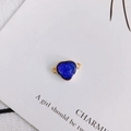 Macro detail of heart-shaped dark blue resin charm with gold-plated metal borders - Dark Blue