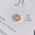 Detail shot of a 17x15mm gold-plated floral pendant with white cubic zirconia stones - Floral Circle with Bowknot (8#)