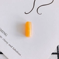 Macro detail of a warm orange translucent resin cylinder bead for DIY jewelry making - Large / Orange (#2)